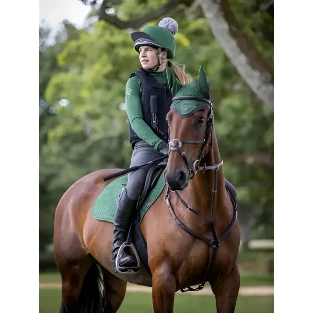 Green riding helmet with pom-pom in lemieux suede close square hunter green for suede close contact use