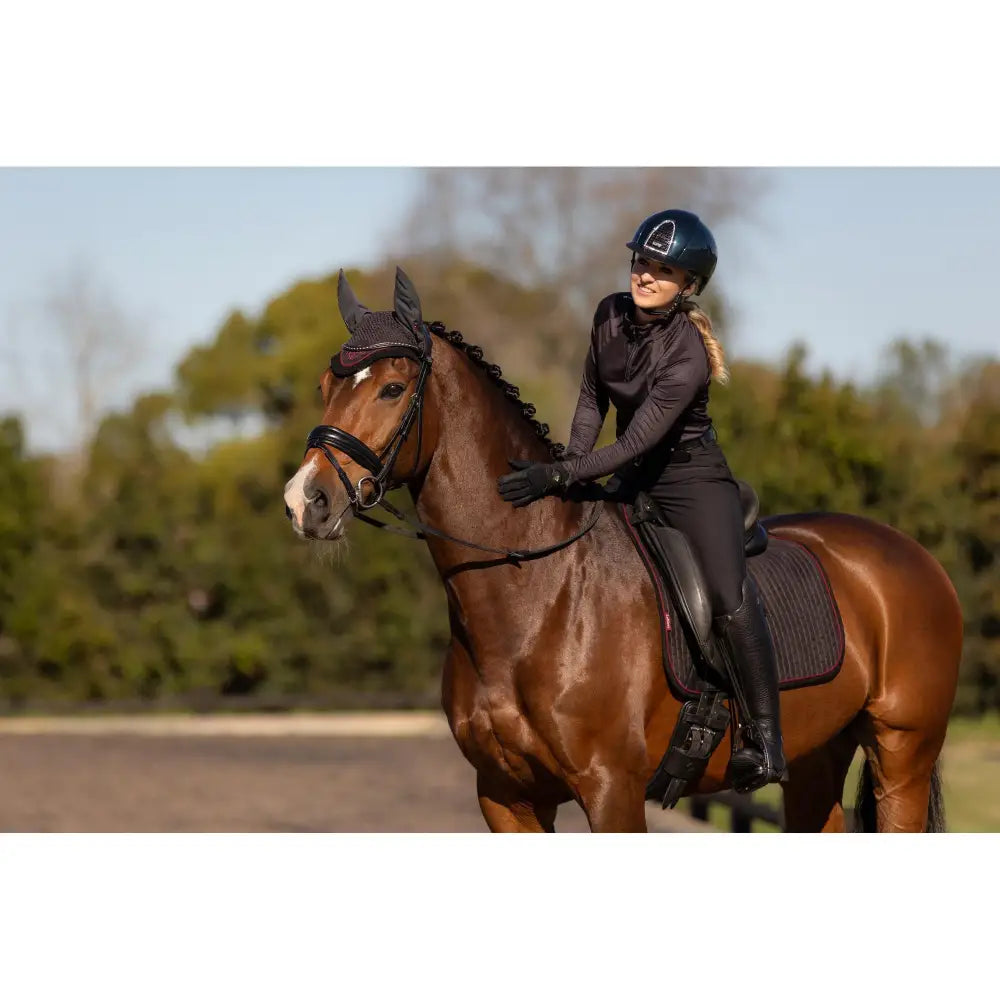 Chestnut horse in equestrian attire on Lemieux Suede Dressage Square Cinder