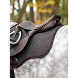 Black quilted lemieux suede gp square saddle pad with red trim and woven texture for classic general purpose use