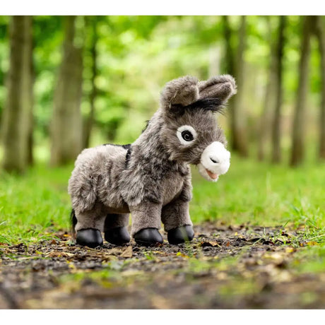 Plush Lemieux Toy Donkey Daphne with gray fur on a forest floor for World Horse Welfare