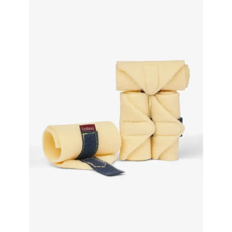 Beige lemieux toy pony fleece polo bandages neatly rolled with dark blue straps ideal for pony bandages glacier use