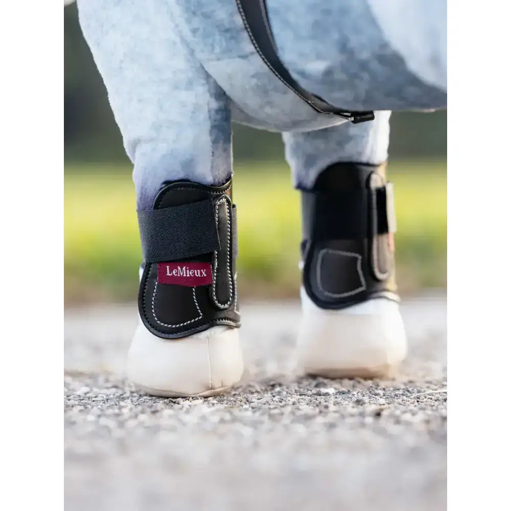 Black lemieux toy pony capella boots with white stitching and red brand label in capella boots black style
