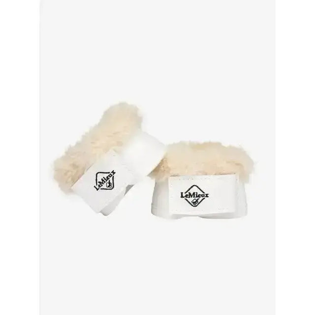White leather lemieux toy pony dressage over reach boots with cream sheepskin lining and black logo in white