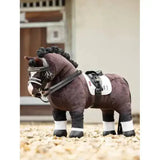 A plush brown lemieux toy pony with black braided mane, white toy pony dressage pad, and detailed bridle
