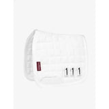 White quilted lemieux toy pony dressage pad with red brand tag and black size labels for pony dressage use