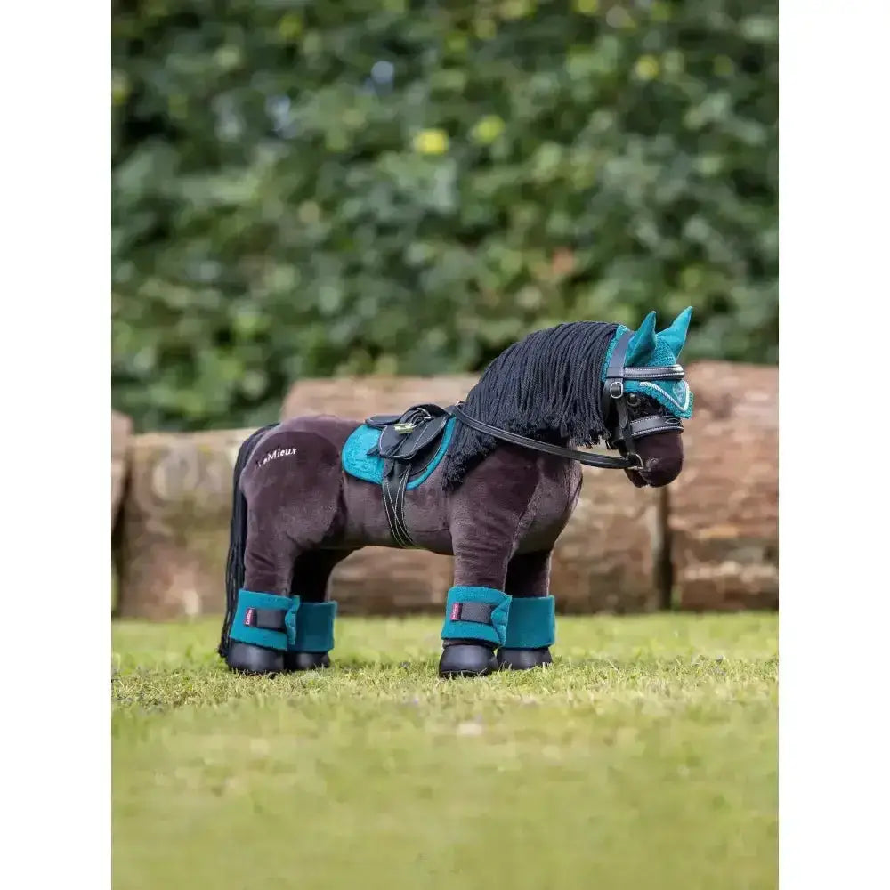Dark brown plush lemieux toy pony with teal fly hood peacock saddle bridle and leg wraps