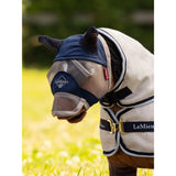 Horse wearing a Lemieux Toy Pony Fly Mask Navy and protective blanket outdoors