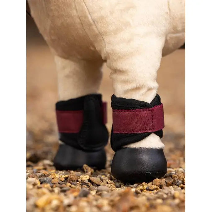 Black and burgundy Lemieux Toy Pony Grafter Boots Ember with velcro straps on furry legs