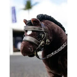 Brown plush lemieux toy pony wearing a dark brown leather pony hunter bridle with silver stitching and gold hardware