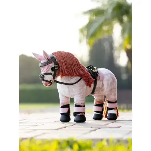 A plush pink lemieux toy pony with a reddish brown mane and saddle pad named pony pad blossom