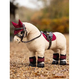 Plush Lemieux Toy Pony in red hat, saddle, and boots on Pony Pad Ember