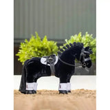 Black plush toy pony with detailed harness white leg wraps featuring lemieux toy pony replica lemieux saddle pad