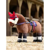 Brown plush lemieux toy pony with red white ear cover black and white striped legs and blue saddle in pony racing bridle set