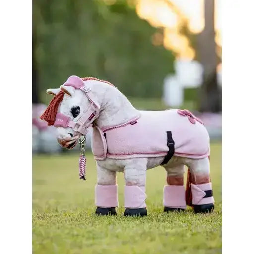 Pink lemieux toy pony wearing a matching pink fleece rug pony rug blossom with hoof covers