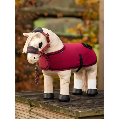 Stuffed toy horse in a red blanket, part of the Lemieux Toy Pony Rug collection