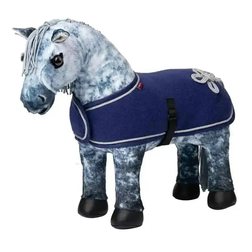 A plush gray dapple horse wearing a navy blue lemieux toy pony fleece rug with white rope trim and silver brooch