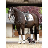 Dark brown horse in riding gear and leg wraps for Toy Pony Valegro