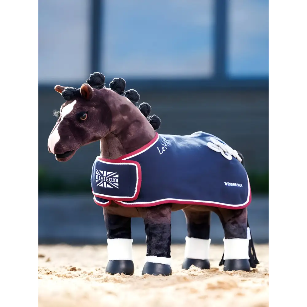 Plush toy pony wearing blue blanket and leg wraps from LeMieux Toy Pony Winners Rug