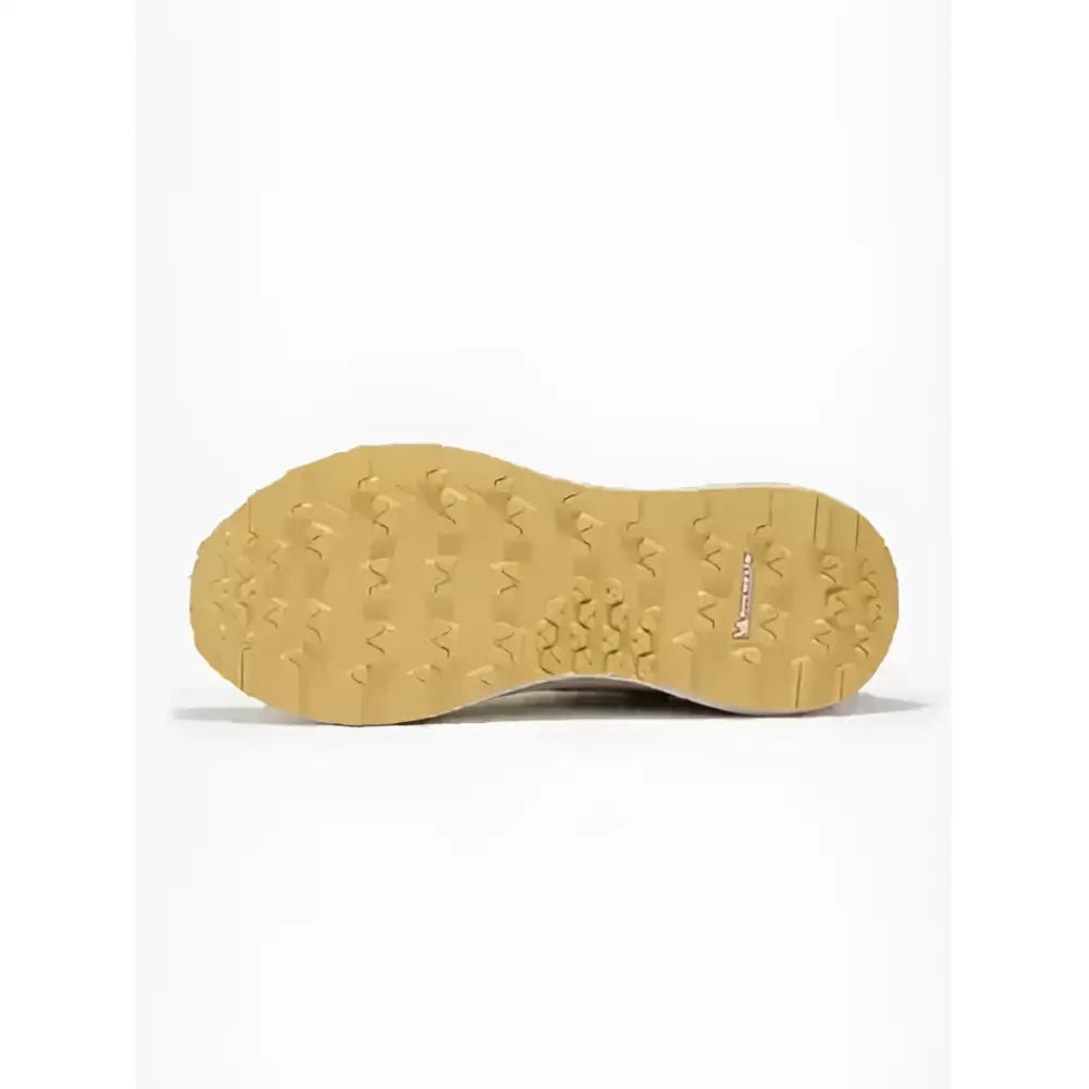 Back of lemlieux trax-lite trainer pecan showing tan rubber sole with wavy tread and mountain logo for equestrian use