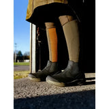 Tan and orange patterned riding socks with textured design worn with black lemieux trax waterproof chelsea boots with stirrup-friendly heel