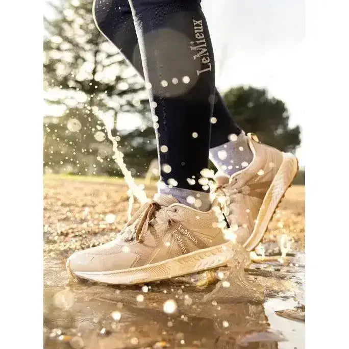 Beige lemieux trax waterproof trainer stone sneakers with textured upper and subtle branding worn with black socks