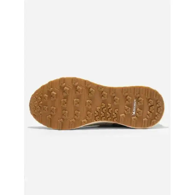 Tan rubber sole with textured tread and mercer logo on the side of lemieux trax waterproof trainer stone