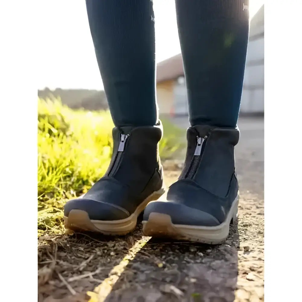 Black leather lemieux trax zip boots with zipper side and tan stirrup-friendly heel soles