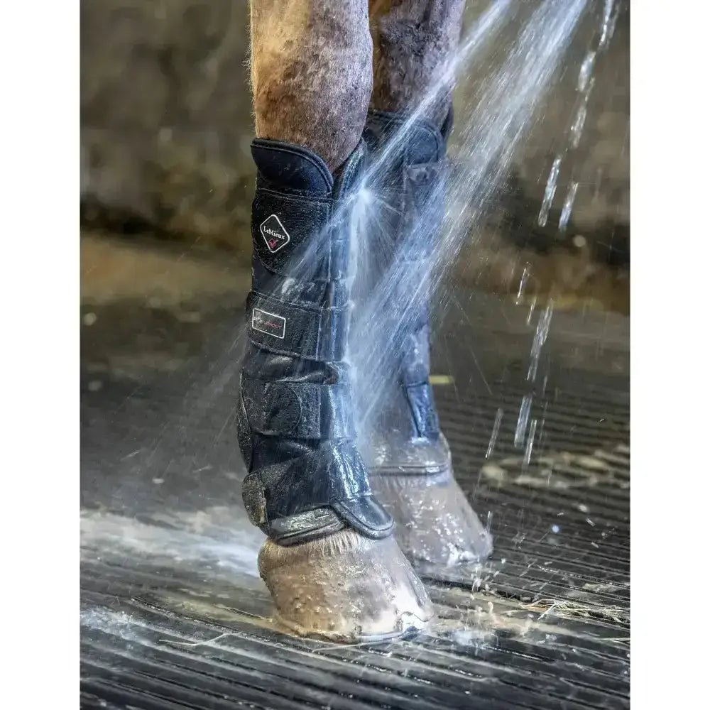Black lemieux turnout boots with antibacterial ventilated neoprene and adjustable straps for horse leg protection