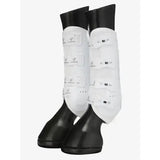 White leather lemieux ultra mesh snug boots hind with black rubber tips and silver logo patches on horse legs
