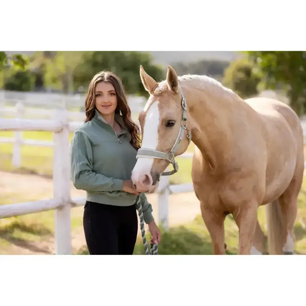 A light green quarter-zip fleece jacket with subtle texture paired with black pants perfect for lemieux versailles headcollar fern fans