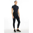 Black short-sleeved equestrian top with high collar and zipper front paired with lemieux victoria breech silicone seat navy
