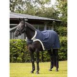 Navy blue lemieux walker rug horse blanket with white fleece trim and black brand tag for maximum stride length