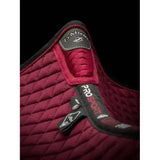 Maroon quilted lemieux wither relief jump pad with black trim and branded tags for comfortable riding