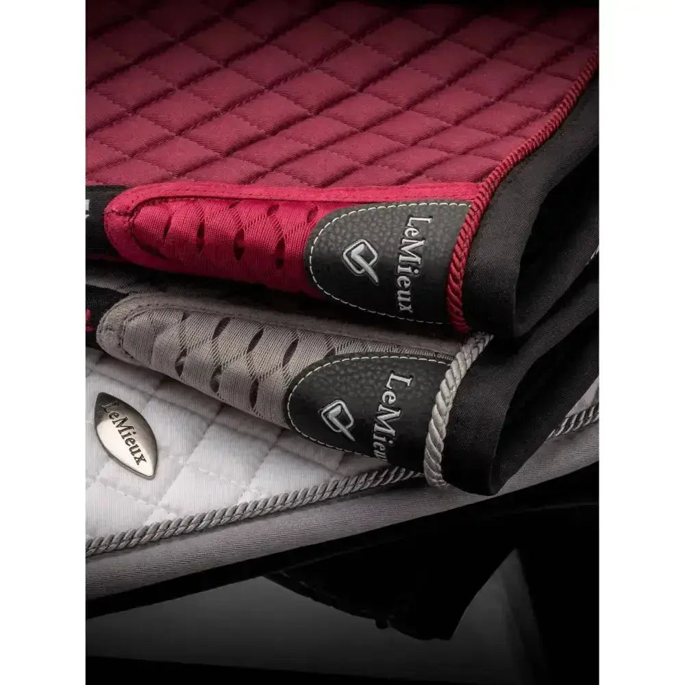 Red and black quilted lemieux wither relief jump pad with braided trim and lemieux brand label in burgundy