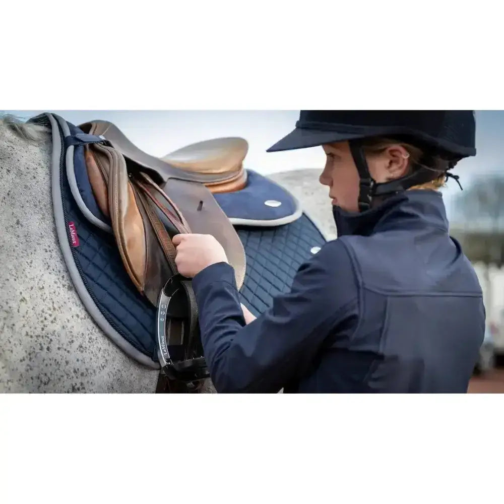 Navy blue quilted lemieux wither relief jump pad with gray trim and red brand tag for wither relief