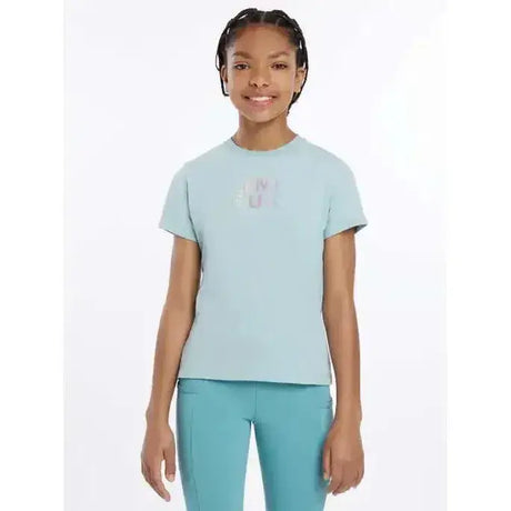 Light blue short-sleeved lemieux young rider t-shirt with subtle iridescent hot fix silver signature lemieux autograph logo
