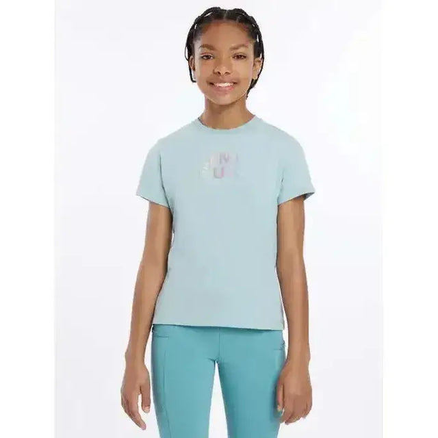 Light blue short-sleeved lemieux young rider t-shirt with subtle iridescent hot fix silver signature lemieux autograph logo