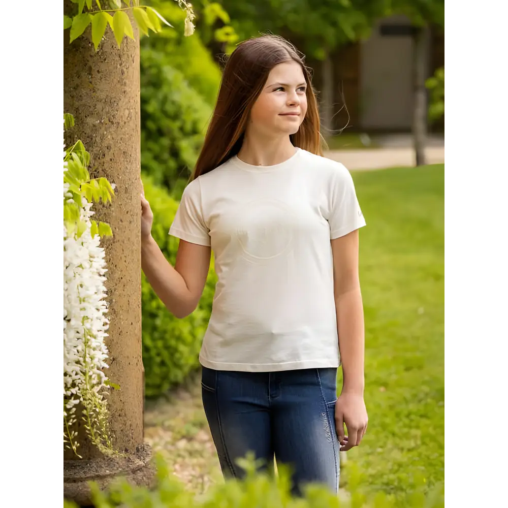 Young woman in white t-shirt and jeans showcases Lemieux Young Rider Arianna T-Shirt Ecru