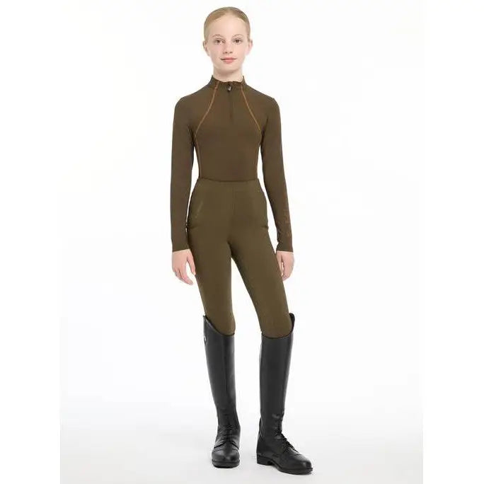 Full-body olive green Lemieux Young Rider Base Layer Alpine with black riding boots