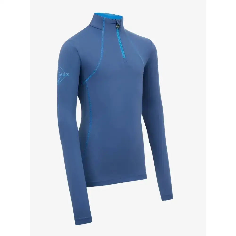Blue long sleeved athletic lemieux young rider base layer with quarter zip and teal zipper trim for young riders running