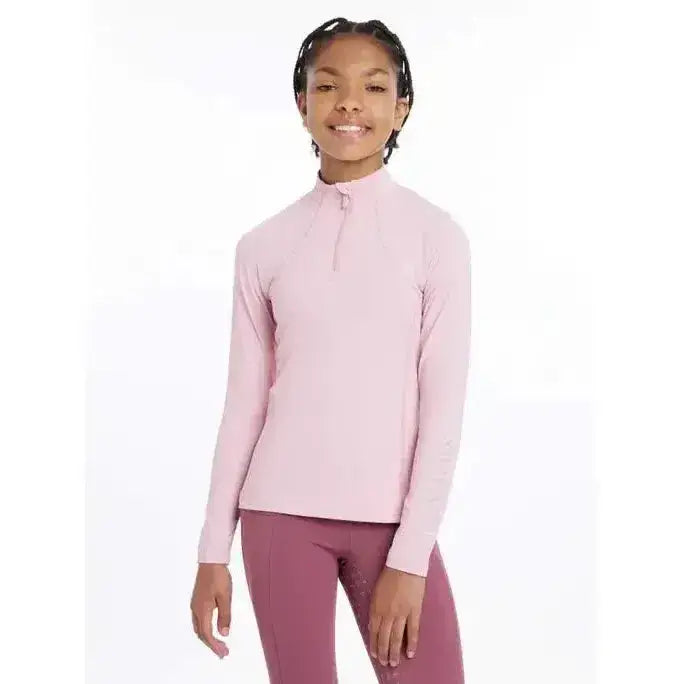 A soft pink lemieux young rider base layer blossom with long sleeves high collar and quarter zip closure