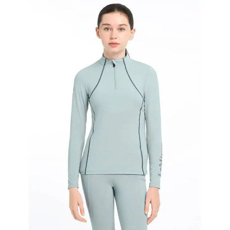 Light blue Lemieux Young Rider Base Layer Glacier worn by a person in action