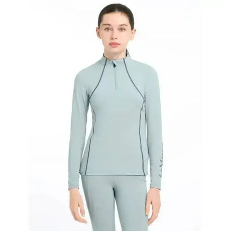 Light blue lemieux young rider base layer glacier with black seams and a half-zip collar for active use