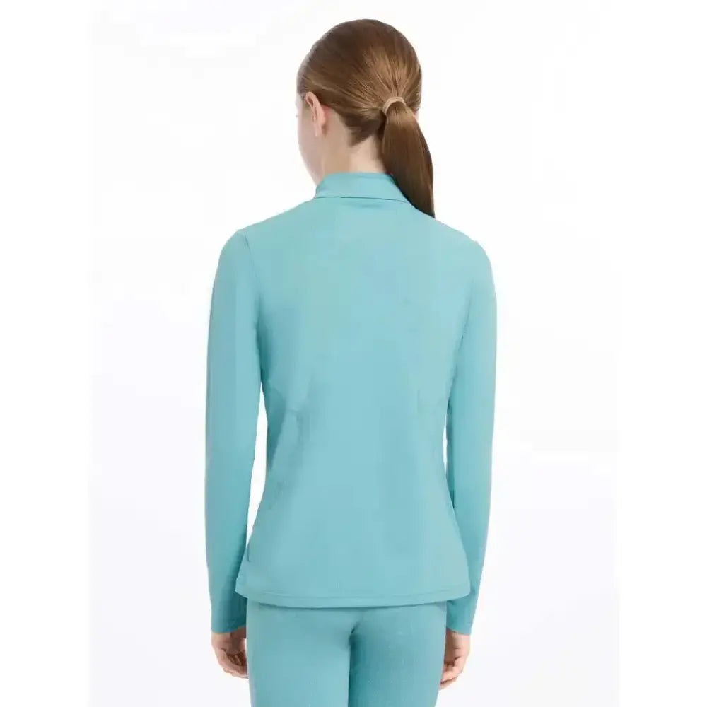 Teal long-sleeved fitted lemieux young rider base layer lagoon with high collar and subtle seam details