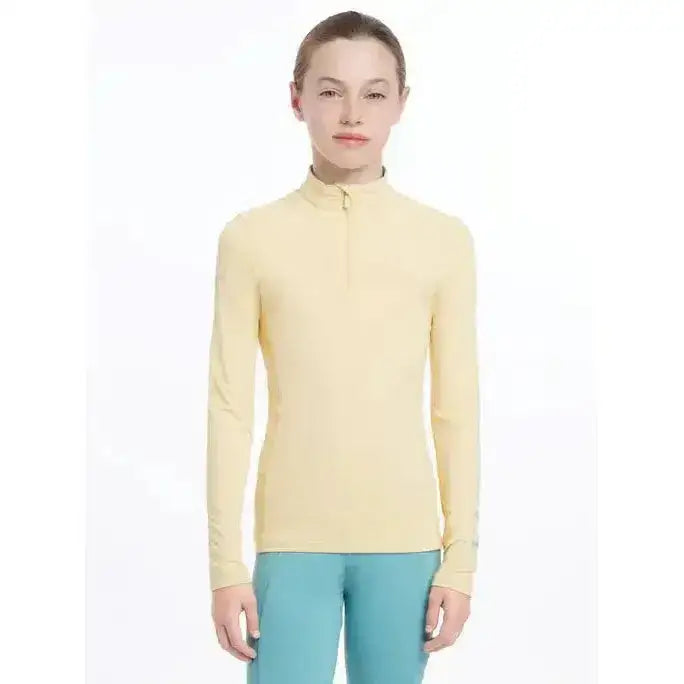 A pale yellow lemieux young rider base layer mimosa with long sleeves and a half-zip collar for performance wear