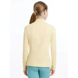 A pale yellow lemieux young rider base layer mimosa polo shirt with long sleeves high collar and ribbed texture
