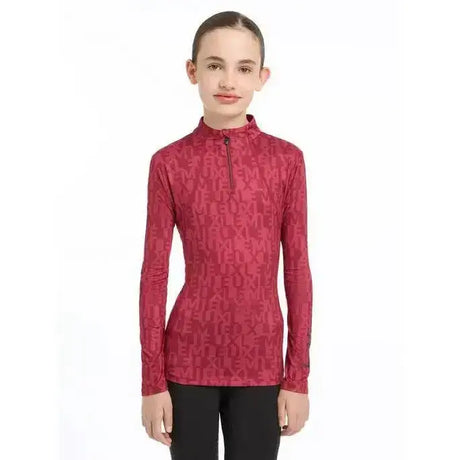 A lemieux young rider casey base layer ember red long-sleeved athletic top with half-zip collar and subtle pattern