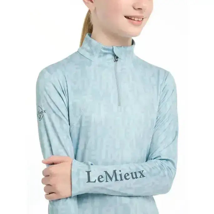 Light blue lemieux young rider casey base layer glacier long-sleeved performance top with subtle texture and sleeve branding