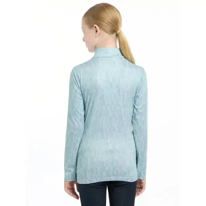 Light blue lemieux young rider casey base layer glacier shirt with textured pattern and high collar for cool rides