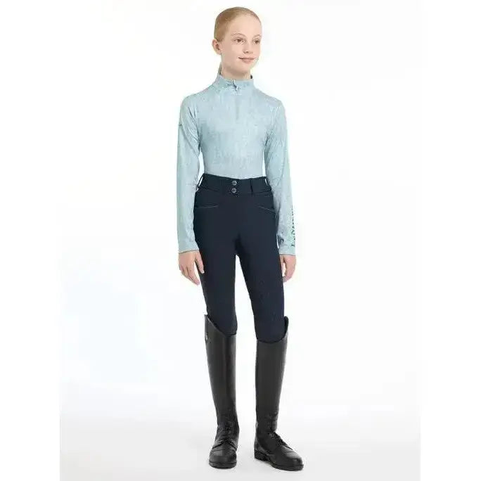Light blue lemieux young rider casey base layer glacier with long sleeves subtle pattern and high collar for riding
